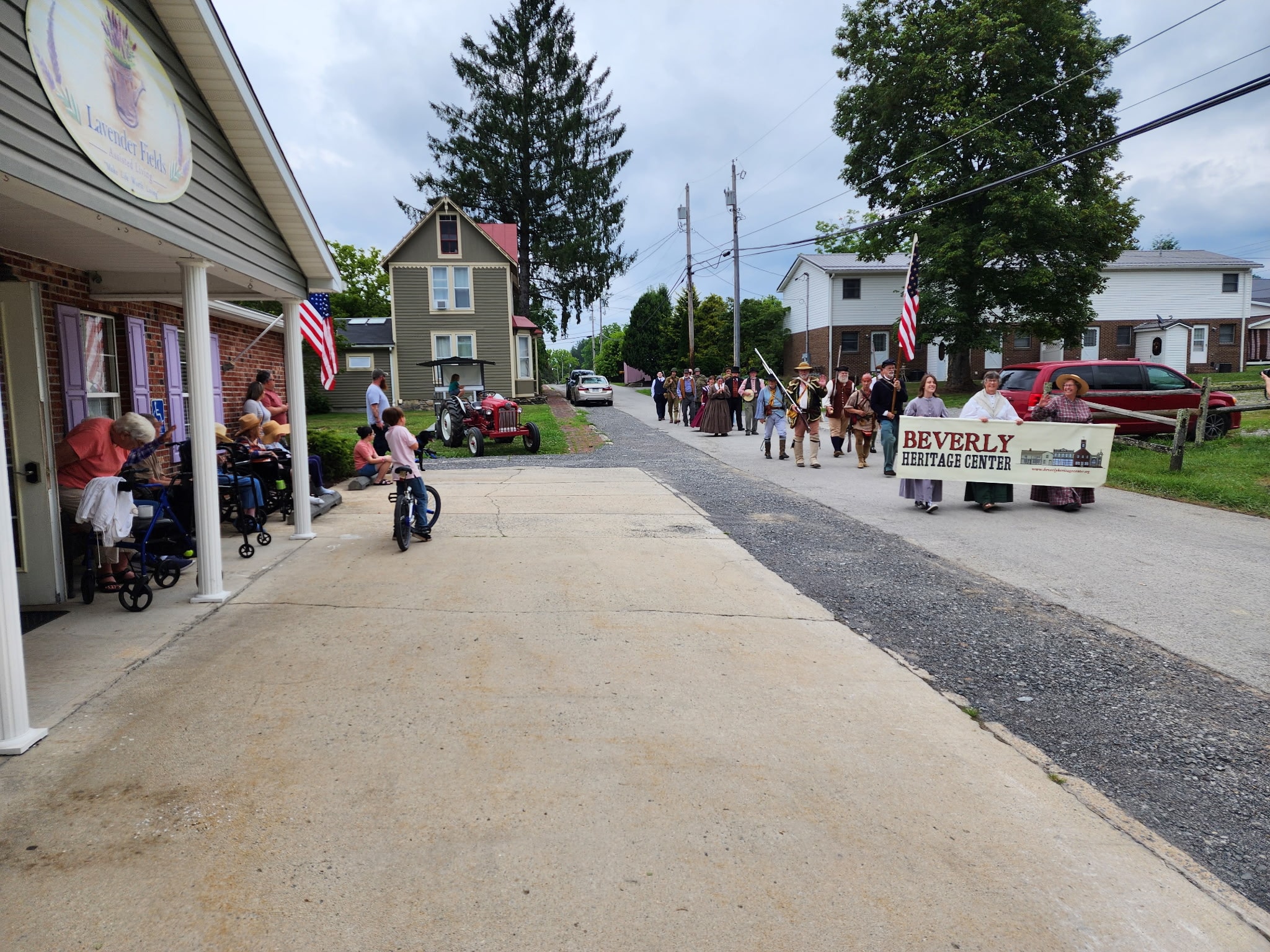 Residents watching the Beverly Heritage Center parade from the Lavender Fields front porch