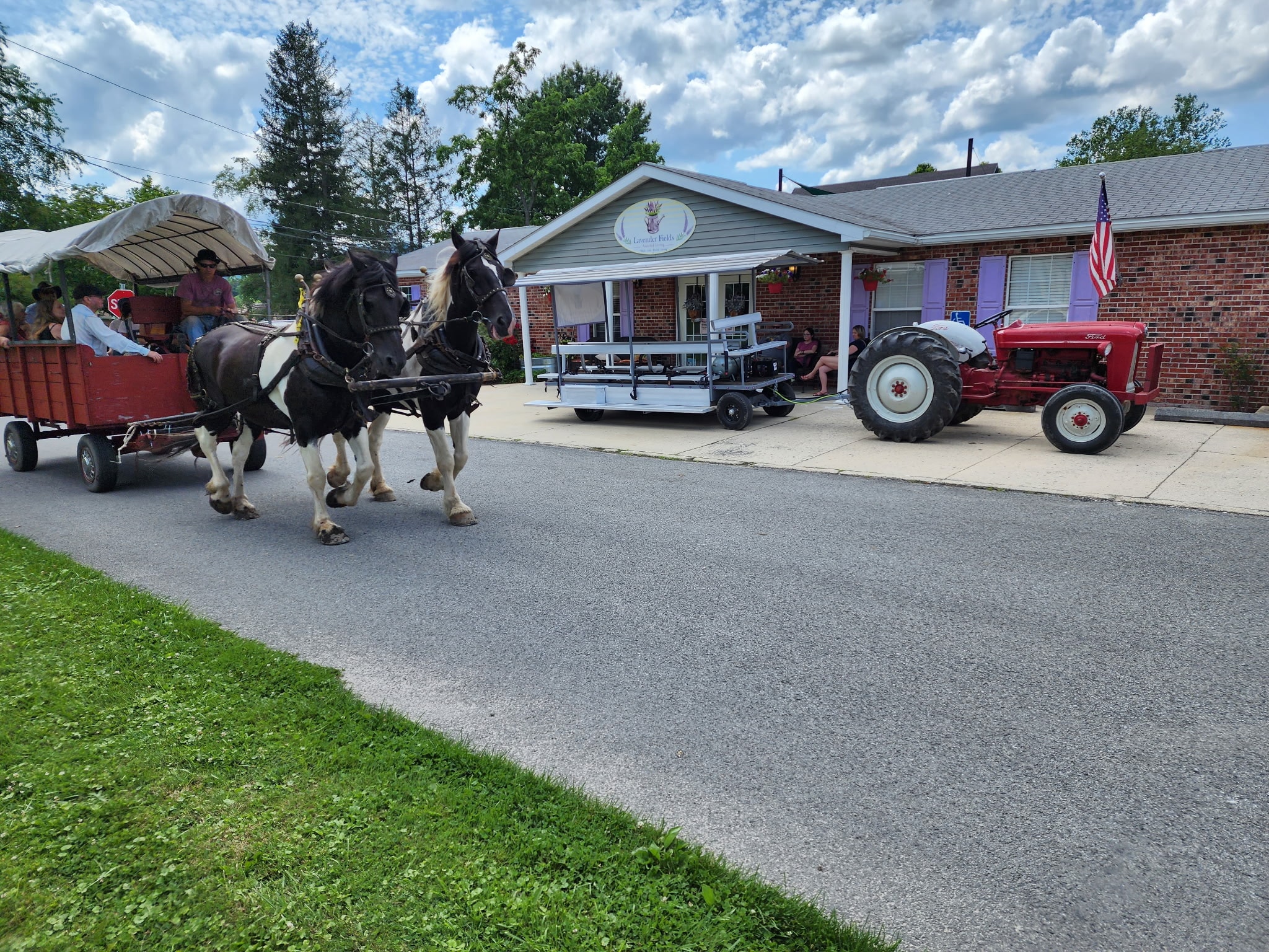 A horse-drawn wagon passes in front of Lavender Fields during a Beverly community event
