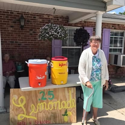 A resident running a lemonade stand on the front porch at Lavender Fields, 25 cents a cup