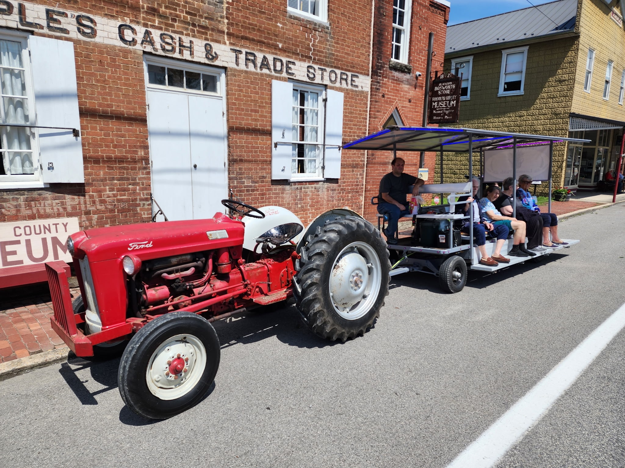 The Lavender Fields red Ford tractor pulling the resident wagon through downtown Beverly
