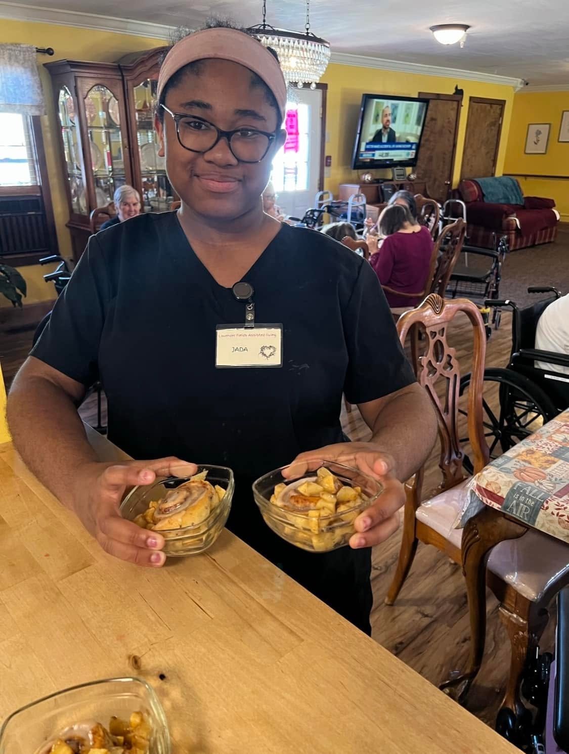 A woman holding cake cups in the Lavender Fields kitchen — meals prepared in the house every day