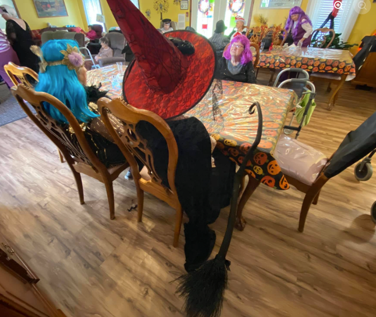 Lavender Fields residents dressed as witches celebrating Halloween together in the dining room